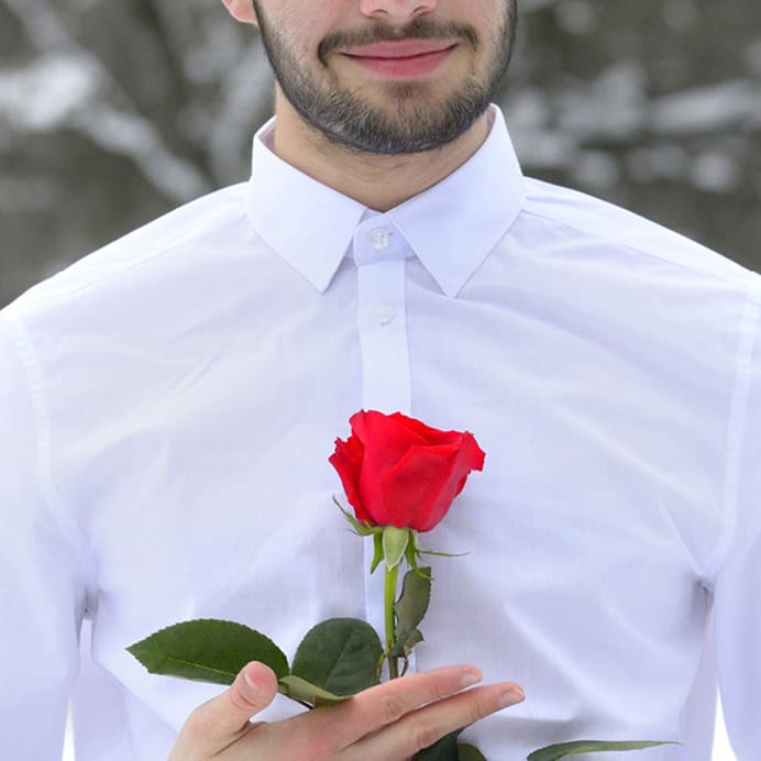 Guy in a shirt holding a rose