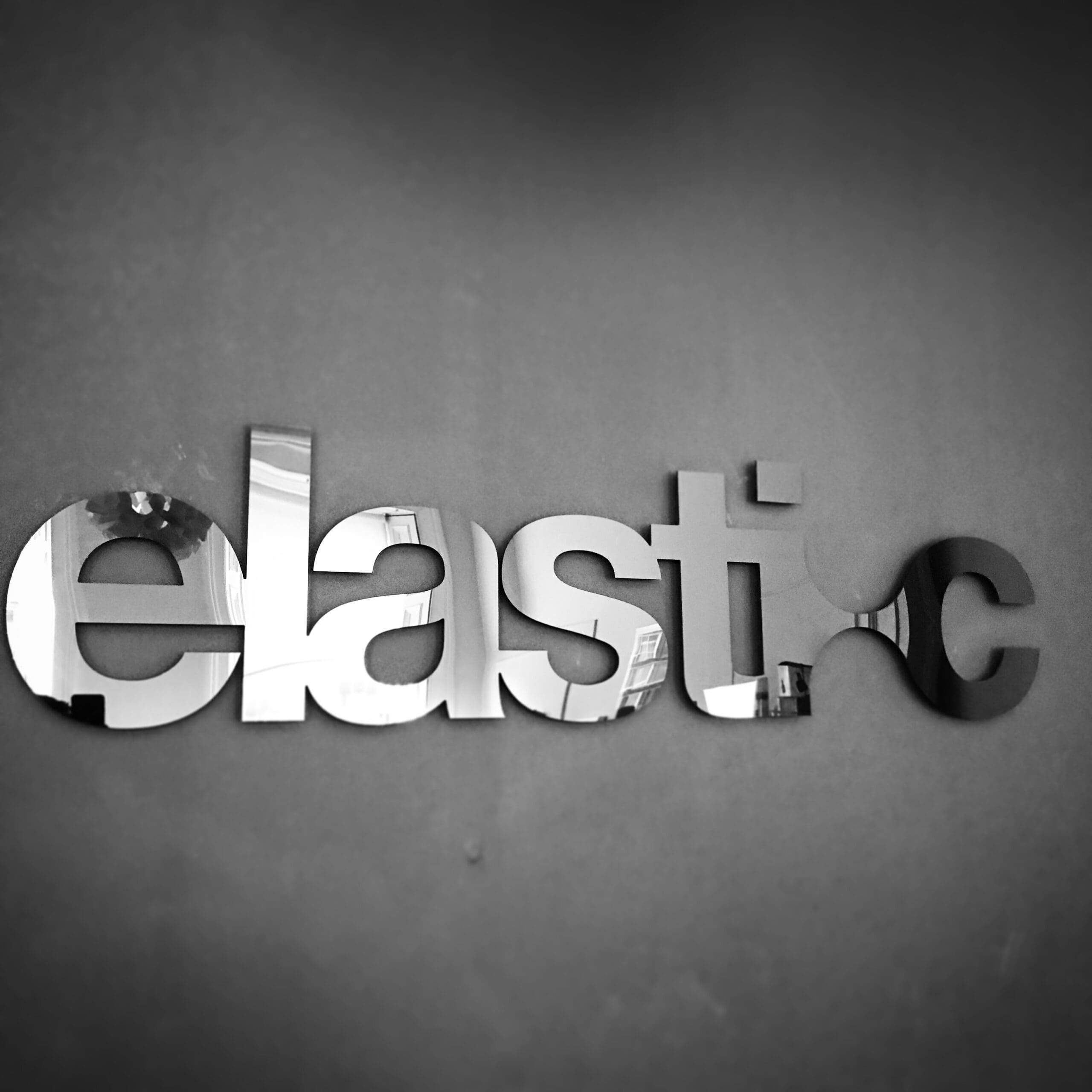 Elastic logo on a black wall